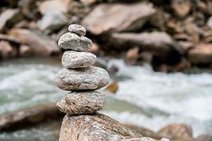 Stack of Stones balanced alongside a river with rapids